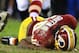Robert Griffin III came back into Sunday's game after reaggravating his knee injury