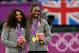 LONDON, ENGLAND - AUGUST 05: Gold medalists Serena Williams of the United States and Venus Williams of the United States celebrate on the popdium during the medal ceremony for the Women's Doubles Tennis on Day 9 of the London 2012 Olympic Games at the All England Lawn Tennis and Croquet Club on August 5, 2012 in London, England. (Photo by Clive Brunskill/Getty Images)