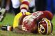 LANDOVER, MD - JANUARY 06: Robert Griffin III #10 of the Washington Redskins is injured as he fumbles a low snap in the fourth quarter against the Seattle Seahawks during the NFC Wild Card Playoff Game at FedExField on January 6, 2013 in Landover, Maryland. (Photo by Al Bello/Getty Images)