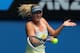 MELBOURNE, AUSTRALIA - JANUARY 14: Maria Sharapova of Russia plays a forehand in her first round match against Olga Puchkova of Russia during day one of the 2013 Australian Open at Melbourne Park on January 14, 2013 in Melbourne, Australia. (Photo by Scott Barbour/Getty Images)
