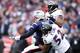 FOXBORO, MA - JANUARY 22: Tom Brady #12 of the New England Patriots gets tackled after throwing the ball by Ray Lewis #52 of the Baltimore Ravens during their AFC Championship Game at Gillette Stadium on January 22, 2012 in Foxboro, Massachusetts. (Photo by Elsa/Getty Images)