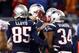 Jan 13, 2013; Foxboro, MA, USA; New England Patriots quarterback Tom Brady (middle) celebrates with teammates Brandon Lloyd (85) and Shane Vereen (34) after a touchdown during the second half of the AFC divisional round playoff game against the Houston Texans at Gillette Stadium. The Patriots won 41-28. Mandatory Credit: Mark L. Baer-USA TODAY Sports