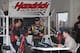 Jeff Gordon talks with team members after a run during testing at Daytona International Speedway. Credit: Dwight Drum
