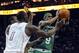 April 15, 2012; Charlotte, NC, USA; Boston Celtics guard Rajon Rondo (9) looks to pass as he is defended by Charlotte Bobcats center Bismack Biyombo (0) and guard Kemba Walker (1) during the game at Time Warner Cable Arena. Mandatory Credit: Sam Sharpe-USA TODAY Sports