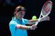 MELBOURNE, AUSTRALIA - JANUARY 15: Roger Federer of Switzerland plays a backhand in his first round match against Benoit Paire of France during day two of the 2013 Australian Open at Melbourne Park on January 15, 2013 in Melbourne, Australia. (Photo by Quinn Rooney/Getty Images)