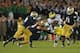 SOUTH BEND, IN - SEPTEMBER 22: (L-R) Bennett Jackson #2, Dan Fox #48 and Ishaq Williams #11 of the Notre Dame Fighting Irish move to bring down Denard Robinson #16 of the Michigan Wolverines at Notre Dame Stadium on September 22, 2012 in South Bend, Indiana. Notre Dame defeated Michigan 13-6.(Photo by Jonathan Daniel/Getty Images)