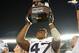 Dec 20, 2012; San Diego, CA, USA; Brigham Young Cougars linebacker Ezekiel Ansah (47) hoists the Poinsettia Bowl Trophy after the Cougars beat the San Diego State Aztecs 23-6 at Qualcomm Stadium. Mandatory Credit: Jake Roth-USA TODAY Sports