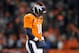 DENVER, CO - JANUARY 12: Peyton Manning #18 of the Denver Broncos walks on the field with his head down against the Baltimore Ravens during the AFC Divisional Playoff Game at Sports Authority Field at Mile High on January 12, 2013 in Denver, Colorado. THe Ravens won 38-35 in the second overtime. (Photo by Dustin Bradford/Getty Images)