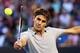 MELBOURNE, AUSTRALIA - JANUARY 19: Roger Federer of Switzerland plays a backhand in his third round match against Bernard Tomic of Australia during day six of the 2013 Australian Open at Melbourne Park on January 19, 2013 in Melbourne, Australia. (Photo by Cameron Spencer/Getty Images)