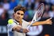 MELBOURNE, AUSTRALIA - JANUARY 19: Roger Federer of Switzerland plays a backhand in his third round match against Bernard Tomic of Australia during day six of the 2013 Australian Open at Melbourne Park on January 19, 2013 in Melbourne, Australia. (Photo by Cameron Spencer/Getty Images)