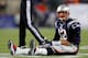 FOXBORO, MA - JANUARY 20: Tom Brady #12 of the New England Patriots sits on the ground after getting knocked down in the fourth quarter against the Baltimore Ravens during the 2013 AFC Championship game at Gillette Stadium on January 20, 2013 in Foxboro, Massachusetts. (Photo by Jim Rogash/Getty Images)