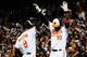BALTIMORE, MD - OCTOBER 08: Adam Jones #10 and Nate McLouth #9 of the Baltimore Orioles celebrate after McLouth and Robert Andino #11 scored on a single hit by Chris Davis #19 in the bottom of the third inning of Game Two of the American League Division Series against the New York Yankees at Oriole Park at Camden Yards on October 8, 2012 in Baltimore, Maryland. (Photo by Patrick McDermott/Getty Images)