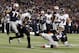 Jan 20, 2013; Foxboro, MA, USA; New England Patriots quarterback Tom Brady (12) slides to avoid a hit from Baltimore Ravens free safety Ed Reed (20) during the second quarter of the AFC championship game at Gillette Stadium. Mandatory Credit: David Butler II-USA TODAY Sports