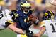 ANN ARBOR, MI - NOVEMBER 17: Denard Robinson #16 of the Michigan Wolverines tries to split the tackles of Louis Trinca-Pasat #90 and Micah Hyde #18 of the Iowa Hawkeyes at Michigan Stadium on November 17, 2012 in Ann Arbor, Michigan. (Photo by Gregory Shamus/Getty Images)