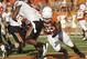 AUSTIN, TX - OCTOBER 15: Defensive end Alex Okafor #80 of the Texas Longhorns tackles running back Joseph Randle #1 of the Oklahoma State Cowboys in the fourth quarter on October 15, 2011 at Darrell K. Royal-Texas Memorial Stadium in Austin, Texas. Oklahoma State beat Texas 38-26. (Photo by Erich Schlegel/Getty Images)