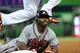 July 24, 2012; Miami, FL, USA; Miami Marlins first baseman Carlos Lee (top) leaps over Atlanta Braves center fielder Michael Bourn (bottom) as Bourn dives back to first base during the first inning at Marlins Park. Mandatory Credit: Steve Mitchell-USA TODAY Sports
