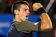 MELBOURNE, AUSTRALIA - JANUARY 24: Novak Djokovic of Serbia celebrates winning his Semifinal match against David Ferrer of Spain during day eleven of the 2013 Australian Open at Melbourne Park on January 24, 2013 in Melbourne, Australia. (Photo by Cameron Spencer/Getty Images)