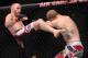 September 22, 2012; Toronto, ON, CANADA; TJ Grant (left) kicks Evan Dunham in the lightweights fight during UFC 152 at the Air Canada Centre. Mandatory Credit: Tom Szczerbowski-USA TODAY Sports