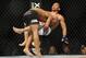 Jan 26, 2013; Chicago, IL, USA; Demetrious Johnson (black shorts) fights John Dodson (white shorts) during UFC on FOX 6 for the world flyweight championship at the United Center. Mandatory Credit: David Banks-USA TODAY Sports
