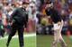 (FILE PHOTO) In this composite image a comparison has been made between Head coach John Harbaugh of the Baltimore Ravens (L) and his brother Head coach Jim Harbaugh of the San Francisco 49ers. Jim and John Harbaugh will become the first brothers to face each other as coaches in the Super Bowl. ***LEFT IMAGE*** LANDOVER, MD - DECEMBER 09: Head coach John Harbaugh of the Baltimore Ravens looks on from the sidelines during the first half of the Ravens 31-28 overtime loss to the Washington Redskins at FedExField on December 9, 2012 in Landover, Maryland. (Photo by Rob Carr/Getty Images) ***RIGHT IMAGE*** SAN FRANCISCO, CA - JANUARY 22: Head coach Jim Harbaugh of the San Francisco 49ers gestures during the NFC Championship Game against the New York Giants at Candlestick Park on January 22, 2012 in San Francisco, California. (Photo by Ezra Shaw/Getty Images)