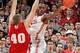 Thomas swings a pass while Wisconsin's Jared Berggren defends.