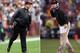 (FILE PHOTO) In this composite image a comparison has been made between Head coach John Harbaugh of the Baltimore Ravens (L) and his brother Head coach Jim Harbaugh of the San Francisco 49ers. Jim and John Harbaugh will become the first brothers to face each other as coaches in the Super Bowl. ***LEFT IMAGE*** LANDOVER, MD - DECEMBER 09: Head coach John Harbaugh of the Baltimore Ravens looks on from the sidelines during the first half of the Ravens 31-28 overtime loss to the Washington Redskins at FedExField on December 9, 2012 in Landover, Maryland. (Photo by Rob Carr/Getty Images) ***RIGHT IMAGE*** SAN FRANCISCO, CA - JANUARY 22: Head coach Jim Harbaugh of the San Francisco 49ers gestures during the NFC Championship Game against the New York Giants at Candlestick Park on January 22, 2012 in San Francisco, California. (Photo by Ezra Shaw/Getty Images)