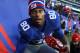 EAST RUTHERFORD, NJ - DECEMBER 30: Victor Cruz #80 of the New York Giants takes off hsi shoes to give to fans after the game against the Philadelphia Eagles at MetLife Stadium on December 30, 2012 in East Rutherford, New Jersey. The New York Giants defeated the Philadelphia Eagles 42-7. (Photo by Elsa/Getty Images)