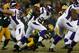 GREEN BAY, WI - JANUARY 05: Running back Adrian Peterson #28 of the Minnesota Vikings runs the ball against safety Charles Woodson #21 of the Green Bay Packers in the first quarter during the NFC Wild Card Playoff game at Lambeau Field on January 5, 2013 in Green Bay, Wisconsin. (Photo by Jonathan Daniel/Getty Images)