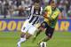 TURIN, ITALY - SEPTEMBER 22: Mirko Vucinic of Juventus FC competes for the ball with Luca Rigoni of AC Chievo Verona during the Serie A match between FC Juventus v AC Chievo Verona at Juventus Arena on September 22, 2012 in Turin, Italy. (Photo by Marco Luzzani/Getty Images)