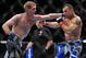 Feb 2, 2013; Las Vegas, NV, USA; Evan Dunham (left) lands a straight left on Gleison Tibau (right) during UFC 156 at the Mandalay Bay Events Center. Mandatory Credit: Gary A. Vasquez-USA TODAY Sports
