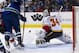 VANCOUVER, CANADA - JANUARY 23: Goalie Miikka Kiprusoff #34 of the Calgary Flames reaches out to make a glove save during the second period of NHL action against the Vancouver Canucks on January 23, 2013 at Rogers Arena in Vancouver, British Columbia, Canada. (Photo by Rich Lam/Getty Images)