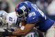 ARLINGTON, TX - OCTOBER 28: Tony Romo #9 of the Dallas Cowboys is sacked by Chris Canty #99 of the New York Giants at Cowboys Stadium on October 28, 2012 in Arlington, Texas. (Photo by Ronald Martinez/Getty Images)