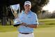 PACIFIC PALISADES, CA - FEBRUARY 19: Bill Haas poses with the trophy after his win on the second playoff hole against Phil Mickelson and Keegan Bradley during the fourth round of the Northern Trust Open at the Riviera Country Club on February 19, 2012 in Pacific Palisades, California. (Photo by Harry How/Getty Images)