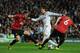 MADRID, SPAIN - FEBRUARY 13: Cristiano Ronaldo of Real Madrid is put under pressure by Jonny Evans and Phil Jones of Manchester United during the UEFA Champions League Round of 16 first leg match between Real Madrid and Manchester United at Estadio Santiago Bernabeu on February 13, 2013 in Madrid, Spain. (Photo by Gonzalo Arroyo Moreno/Getty Images)