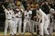 CHICAGO, IL - AUGUST 10: Members of the Chicago White Sox including (L-R) Gordan Beckham #15, Ray Olmedo #66, Tyler Flowers #17 and Alexei Ramirez #10, welcome Jordan Danks #7 who hit a walk-off home run to defeat the Oakland Athletics at U.S. Cellular Field on August 10, 2012 in Chicago, Illinois. The White Sox defeated the Athletics 4-3. (Photo by Jonathan Daniel/Getty Images)