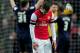 LONDON, ENGLAND - FEBRUARY 16: Dejected Arsenal player Jack Wilshere looks on as Blackburn players celebrate their team's 1-0 victory during the FA Cup with Budweiser fifth round match between Arsenal and Blackburn Rovers at Emirates Stadium on February 16, 2013 in London, England. (Photo by Shaun Botterill/Getty Images)