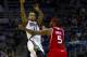 Mar 27, 2012; Milwaukee, WI, USA; Milwaukee Bucks guard Monta Ellis (11) passes the ball over Atlanta Hawks forward Josh Smith (5) during the third quarter at the Bradley Center. Mandatory Credit: Jeff Hanisch-USA TODAY Sports