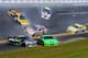 DAYTONA BEACH, FL - FEBRUARY 20: Marcos Ambrose, driver of the #9 Stanley Ford, David Reutimann, driver of the #00 Aaron's Dream Machine Toyota, Brian Vickers, driver of the #83 Red Bull Toyota, Jimmie Johnson, driver of the #48 Lowe's Chevrolet, Mark Martin, driver of the #5 GoDaddy.com Chevrolet, and Travis Kvapil, driver of the #38 Long John Silver's Ford, are involved in an incident during the NASCAR Sprint Cup Series Daytona 500 at Daytona International Speedway on February 20, 2011 in Daytona Beach, Florida. (Photo by John Harrelson/Getty Images for NASCAR)