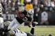OAKLAND, CA - NOVEMBER 18: Taiwan Jones #22 of the Oakland Raiders is tackled by Tom Johnson #96 of the New Orleans Saints at O.co Coliseum on November 18, 2012 in Oakland, California. (Photo by Ezra Shaw/Getty Images)