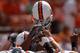 University of Miami huddle with helmets high before play against Clemson September 17, 2005 at Clemson. (Photo by A. Messerschmidt/Getty Images) *** Local Caption ***