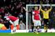 LONDON, ENGLAND - FEBRUARY 16: Dejected Arsenal players Mikel Arteta (L) and Jack Wilshere (R) look on as Blackburn players celebrate their team's 1-0 victory during the FA Cup with Budweiser fifth round match between Arsenal and Blackburn Rovers at Emirates Stadium on February 16, 2013 in London, England. (Photo by Shaun Botterill/Getty Images)