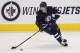 WINNIPEG, MB - FEBRUARY 7: Zach Redmond #25 of the Winnipeg Jets skates on the ice with the puck during a game against the Toronto Maple Leafs in NHL action on February 7, 2013 at the MTS Centre in Winnipeg, Manitoba, Canada. (Photo by Marianne Helm/Getty Images)