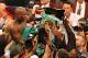 May 5, 2012; Las Vegas, NV, USA; Floyd Mayweather Jr. (center) is hoisted up with all his title belts after beating Miguel Cotto by unanimous decision at MGM Grand Garden Arena. Mandatory Credit: Jake Roth-USA TODAY Sports