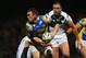 LEEDS, ENGLAND - FEBRUARY 01: Kevin Sinfield of Leeds Rhinos is tackled by Daniel Holdsworth of Hull FC during the Stobart Super League match between Leeds Rhinos and Hull FC at Headingley Carnegie Stadium on February 1, 2013 in Leeds, England. (Photo by Alex Livesey/Getty Images)