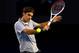 MELBOURNE, AUSTRALIA - JANUARY 25: Roger Federer of Switzerland plays a backhand in his semifinal match against Andy Murray of Great Britain during day twelve of the 2013 Australian Open at Melbourne Park on January 25, 2013 in Melbourne, Australia. (Photo by Julian Finney/Getty Images)