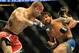 Feb 23, 2013; Anaheim, CA, USA; Dennis Bermudez (red gloves) punches Matt Grice (blue gloves) during their UFC featherweight bout at the Honda Center. Mandatory Credit: Jayne Kamin-Oncea-USA TODAY Sports