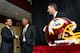 A picture is worth a thousand words and none could be truer with the Redskins in the foreground and team owner, head coach and GM in the background.