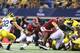 ARLINGTON, TX - SEPTEMBER 01: Dee Hart #1 of the University of Alabama runs for a short gain as Jordan Kovacs #32 of the University of Michigan makes the stop during the game at Cowboys Stadium on September 1, 2012 in Arlington, Texas. Alabama defeated Michigan 41-14. (Photo by Leon Halip/Getty Images)