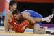 Aug 11, 2012; London, United Kingdom; Coleman Scott (USA), in blue, wrestles with Kenichi Yumoto (JPN) in the men's 60kg freestyle wrestling bronze medal match during the London 2012 Olympic Games at ExCeL. Mandatory Credit: Michael Madrid-USA TODAY Sports