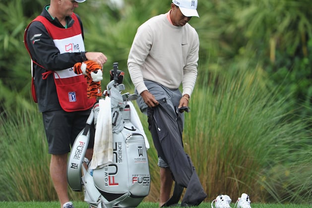 Tiger Woods Changes Clothes and Hits Shot out of Water